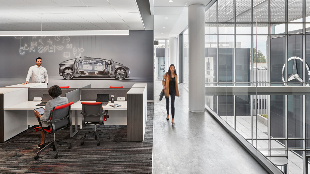 A man and woman walking in an office.